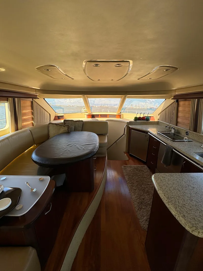 Slide: The Image of Luxurious interior of a 2005 Sea Ray 58 Sedan Bridge yacht with elegant dining area. - 42