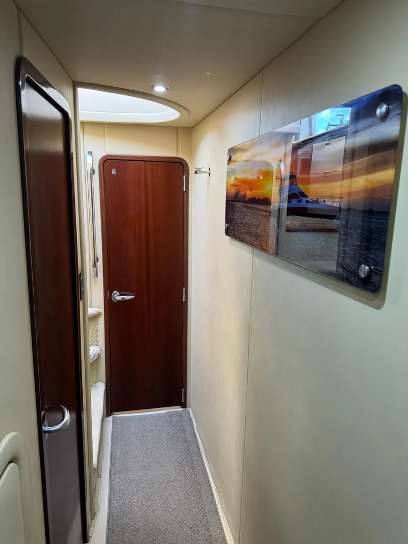 Slide: The Image of Hallway inside 2005 Sea Ray 58 Sedan Bridge yacht with sunset artwork on wall. - 48