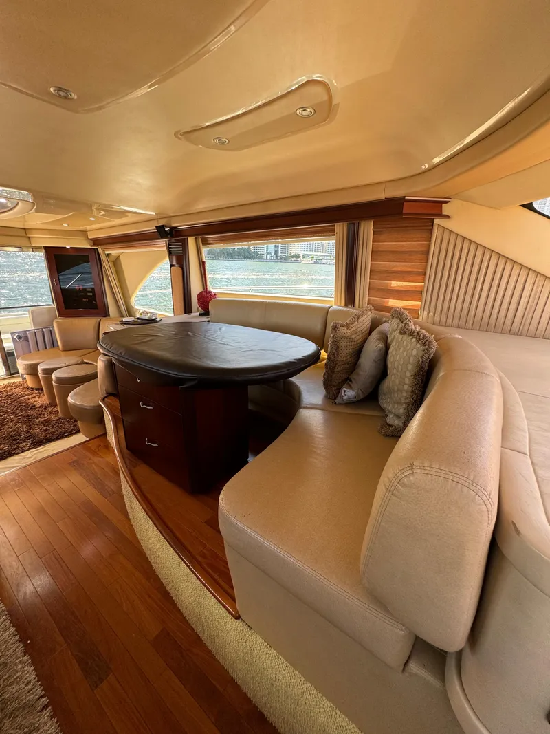 Slide: The Image of Luxurious interior of 2005 Sea Ray 58 Sedan Bridge yacht with elegant seating and dining area. - 49