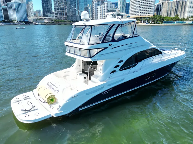 Slide: The Image of 2005 Sea Ray 58 Sedan Bridge yacht on water with city skyline background. - 5