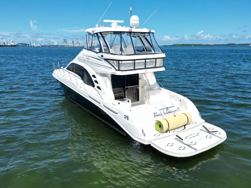 Slide: The Image of 2005 Sea Ray 58 Sedan Bridge yacht on open water, sunny day. - 6