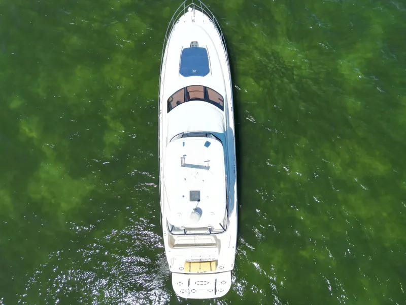 Slide: The Image of Top view of a 2005 Sea Ray 58 Sedan Bridge yacht on green water. - 8