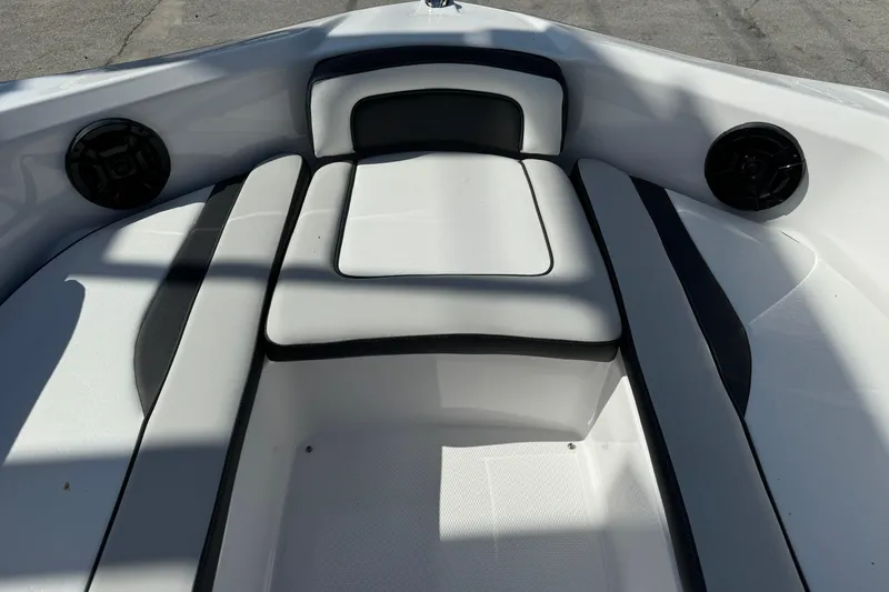 Slide: The Image of 2025 Yamaha Boats SX195 interior seating with sleek white and black design. - 25