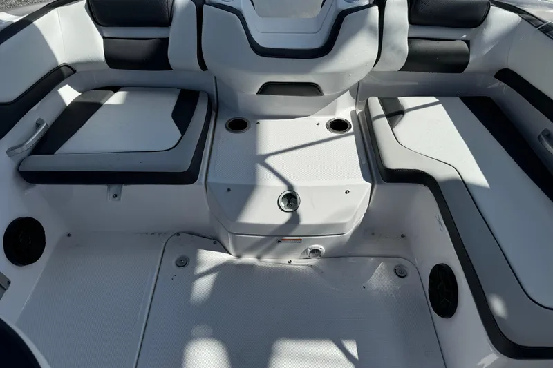 Slide: The Image of 2025 Yamaha Boats SX195 interior seating area with modern design and cup holders. - 30