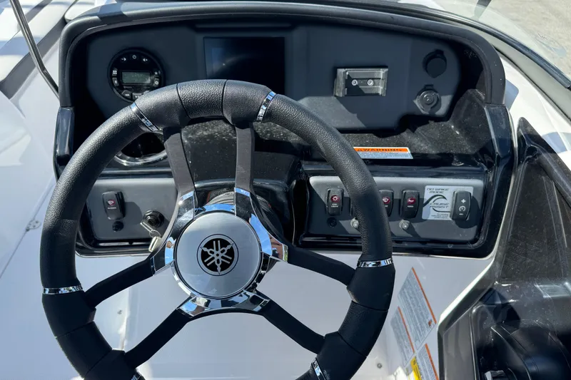 Slide: The Image of Steering wheel and dashboard of 2025 Yamaha Boats SX195, featuring modern controls. - 33