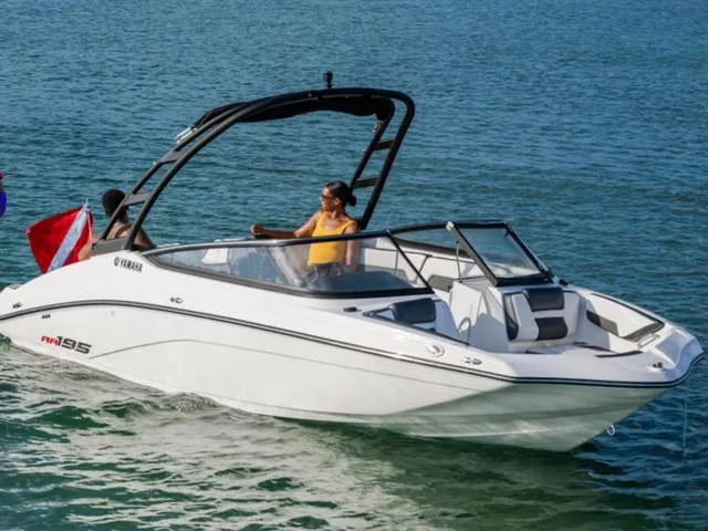 Slide: The Image of 2025 Yamaha SX195 boat cruising on open water with passengers enjoying the ride. - 37