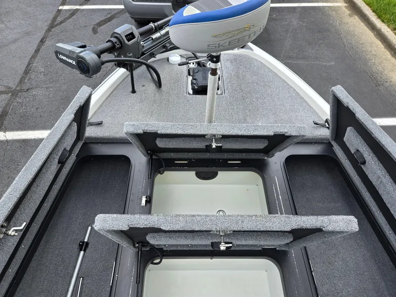Slide: The Image of 2015 Skeeter FX 20 boat with open storage compartments and trolling motor. - 15