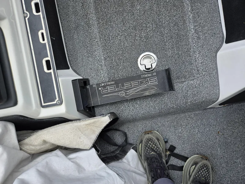 Slide: The Image of 2015 Skeeter FX 20 boat interior with carpeted floor and storage compartment. - 16