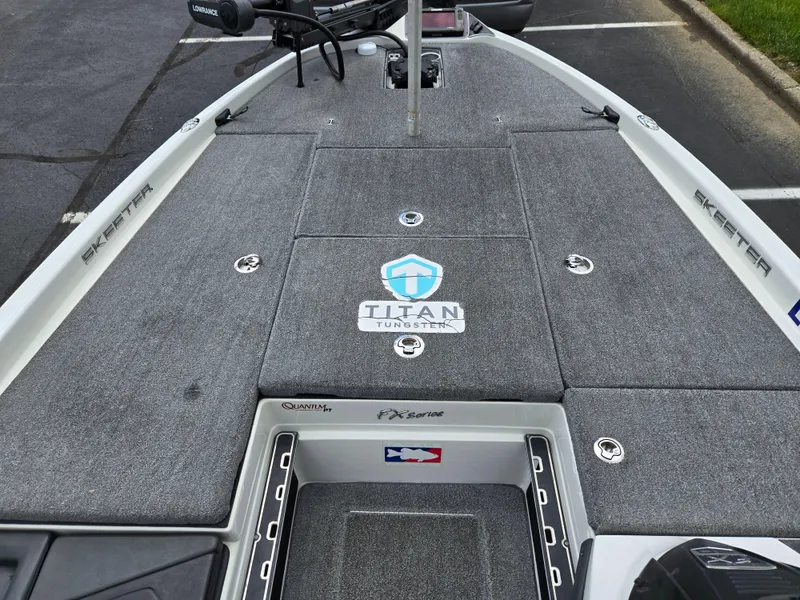 Slide: The Image of 2015 Skeeter FX 20 boat deck with Titan logo and storage compartments. - 17