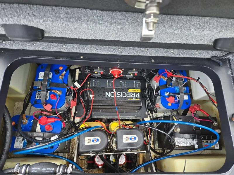 Slide: The Image of 2015 Skeeter FX 20 boat battery compartment with multiple batteries and wiring. - 25