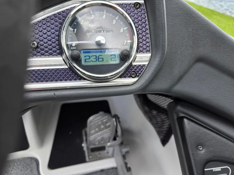 Slide: The Image of Dashboard of a 2015 Skeeter FX 20 boat showing RPM gauge and foot pedal. - 26