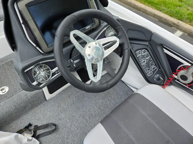 Slide: The Image of 2015 Skeeter FX 20 boat cockpit with steering wheel and control panel. - 28