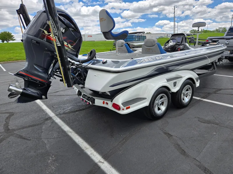 Slide: The Image of 2015 Skeeter FX 20 boat with Yamaha engine on trailer in parking lot. - 3