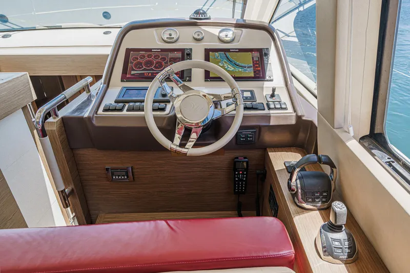 Slide: The Image of Helm of 2017 Beneteau Monte Carlo 5 MC5 yacht with modern controls and red seating. - 43