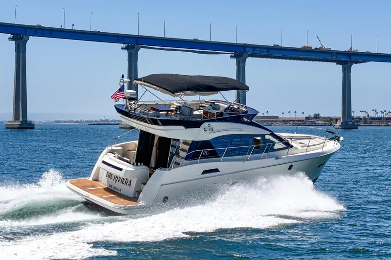 Slide: The Image of 2017 Beneteau Monte Carlo 5 MC5 yacht cruising under a bridge on a sunny day. - 8