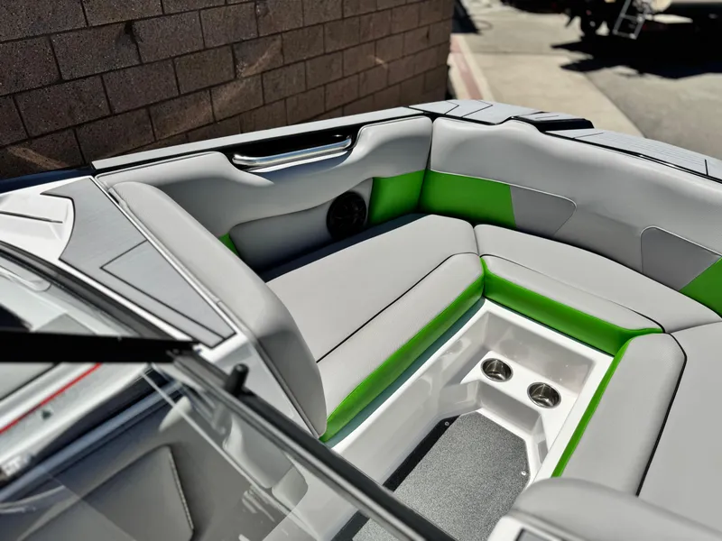 Slide: The Image of 2020 Moomba Max boat interior with gray and green seating, cup holders, and sleek design. - 13