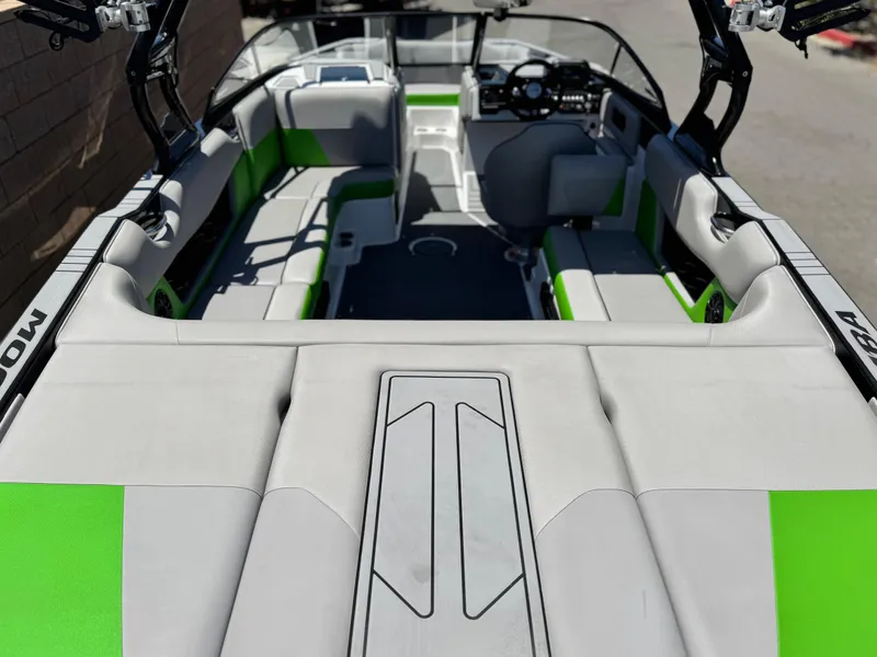 Slide: The Image of 2020 Moomba Max boat interior with green and gray seating, showcasing modern design. - 15