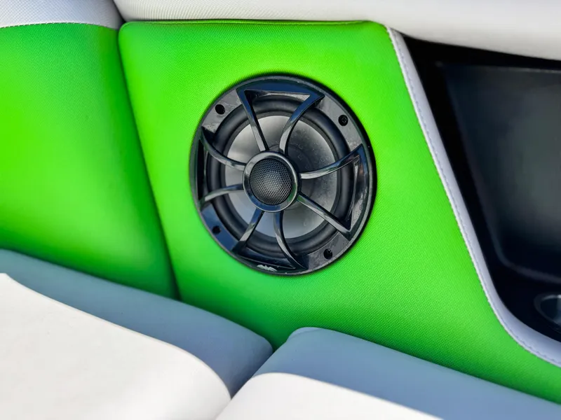 Slide: The Image of 2020 Moomba Max boat interior with green upholstery and speaker detail. - 23