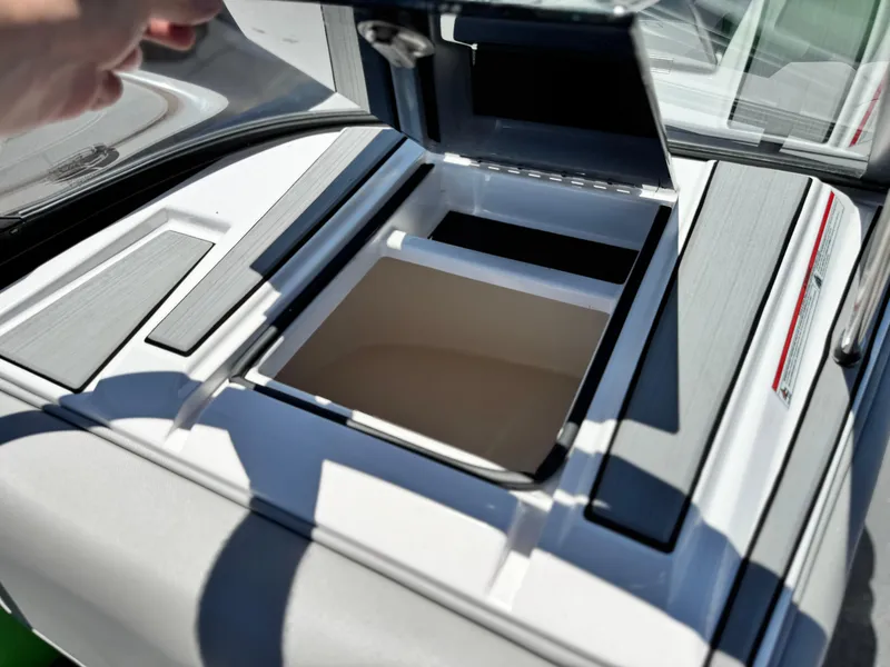 Slide: The Image of 2020 Moomba Max boat storage compartment with open lid, showcasing interior space. - 25