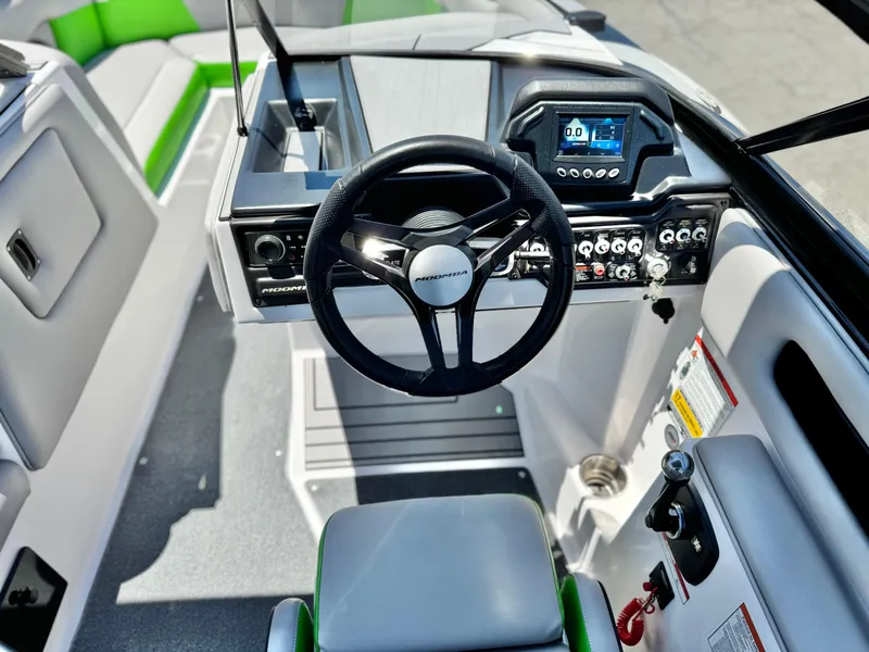Slide: The Image of 2020 Moomba Max boat interior with steering wheel and control panel. - 29