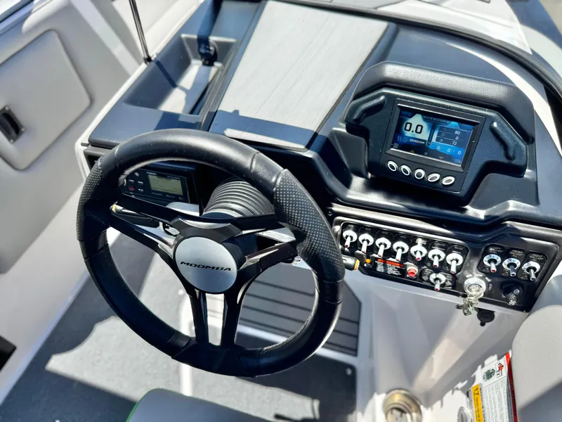 Slide: The Image of 2020 Moomba Max boat dashboard with steering wheel and control panel. - 30