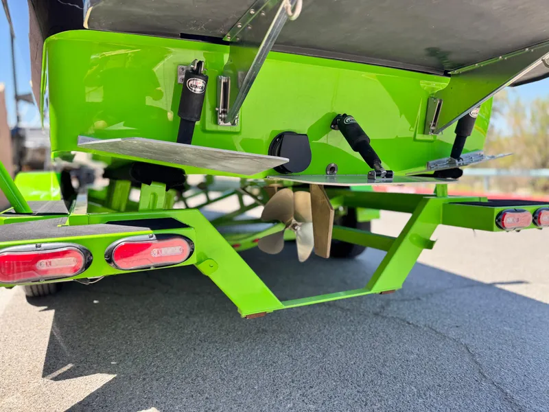 Slide: The Image of Rear view of a 2020 Moomba Max boat with vibrant green hull and propeller. - 7