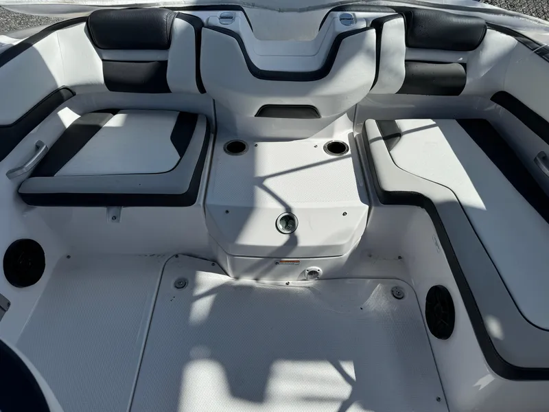 Slide: The Image of 2025 Yamaha SX195 boat interior with sleek seating and cup holders. - 13