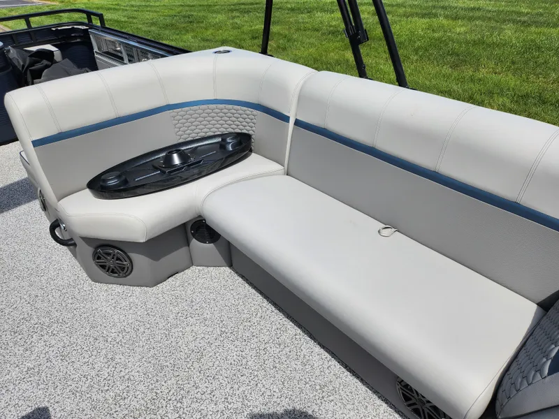 Slide: The Image of 2023 Qwest 8522 Pro Family Fish boat interior with cushioned seating and cup holders. - 12