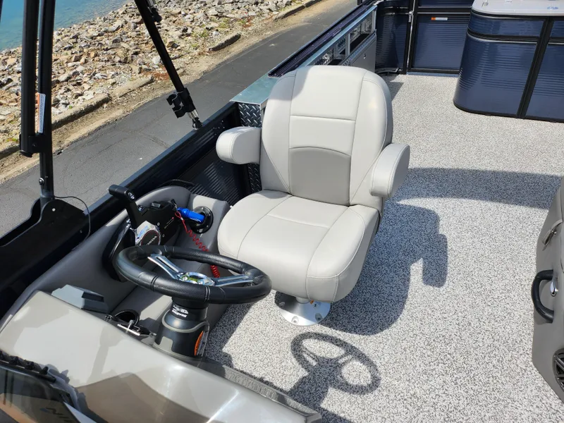 Slide: The Image of 2023 Qwest 8522 Pro Family Fish boat interior with captain's chair and steering wheel. - 13