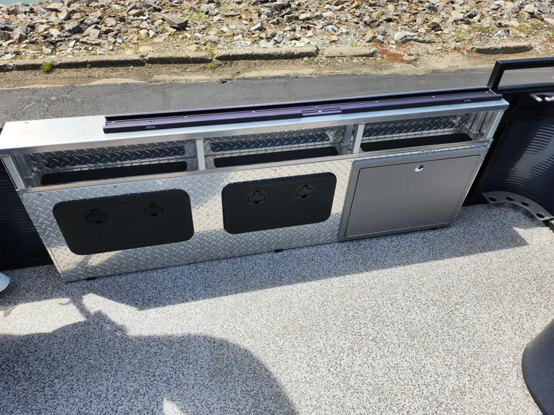 Slide: The Image of 2023 Qwest 8522 Pro Family Fish boat storage compartment with diamond plate design. - 15