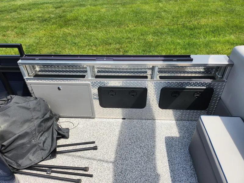 Slide: The Image of 2023 Qwest 8522 Pro Family Fish boat interior with storage compartments and seating. - 17