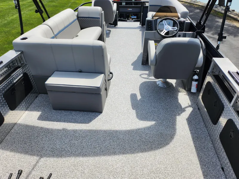 Slide: The Image of 2023 Qwest 8522 Pro Family Fish boat interior with gray seating and steering wheel. - 24