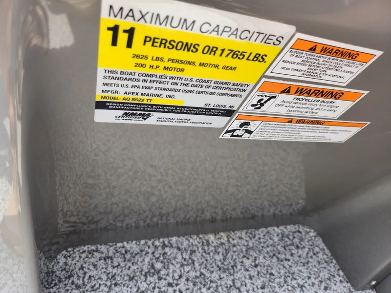 Slide: The Image of 2023 Qwest 8522 Pro Family Fish capacity label, 11 persons or 1765 lbs, safety warnings. - 28