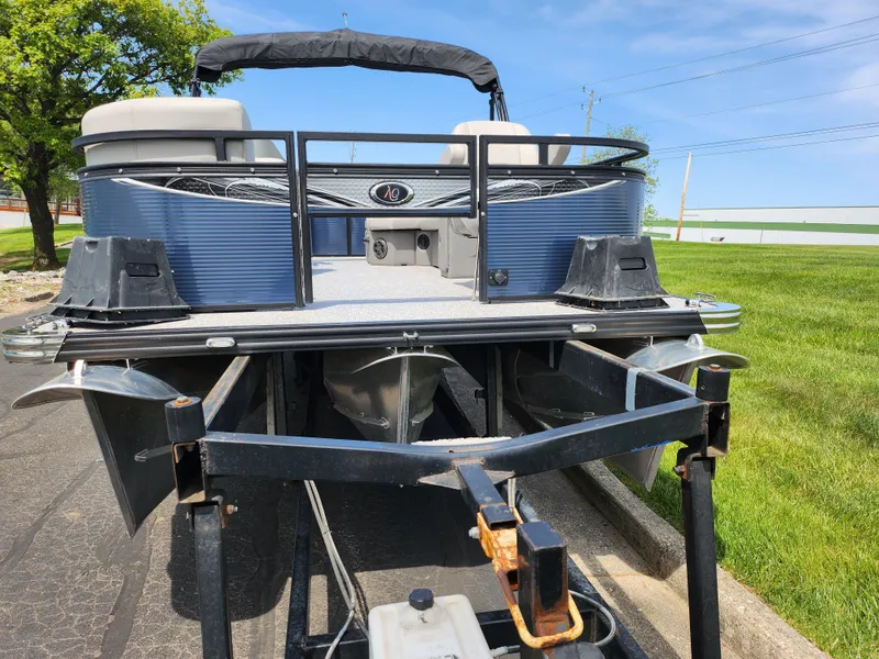 Slide: The Image of 2023 Qwest 8522 Pro Family Fish boat on trailer, parked on a sunny day. - 6