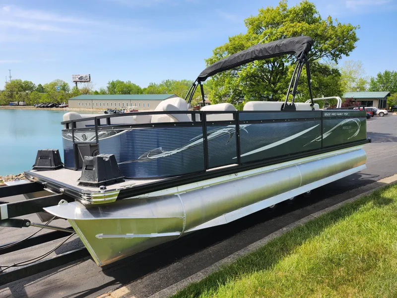 Slide: The Image of 2023 Qwest 8522 Pro Family Fish pontoon boat on trailer by a lake. - 8