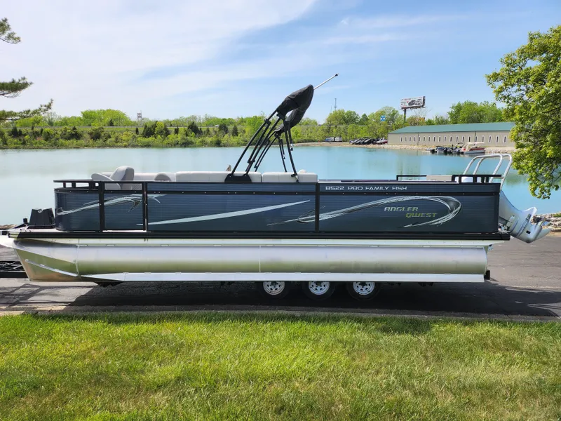 Slide: The Image of 2023 Qwest 8522 Pro Family Fish pontoon boat by a serene lake. - 9