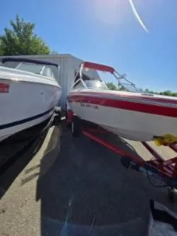 Slide: The Image of 2005 Four Winns 200 Horizon SS boat on trailer, parked outdoors under clear sky. - 3