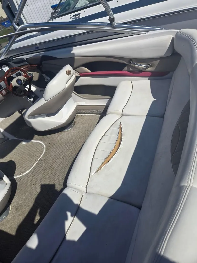 Slide: The Image of 2005 Four Winns 200 Horizon SS boat interior with white seating and steering wheel. - 6