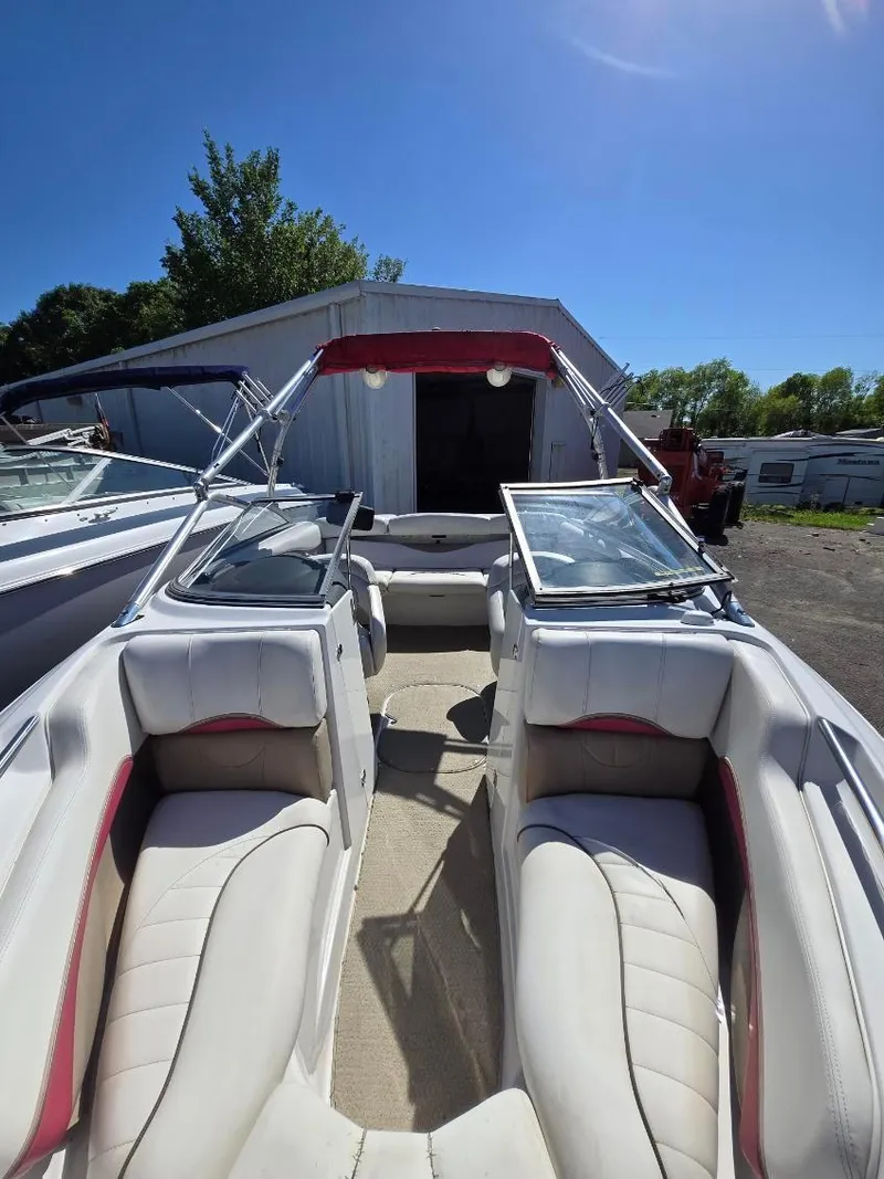 Slide: The Image of 2005 Four Winns 200 Horizon SS boat interior with white seating and open windshield. - 9
