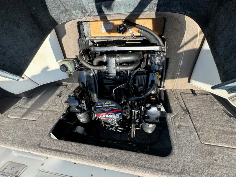 Slide: The Image of Engine compartment of a 2003 Bayliner 212 boat, featuring a Mercury 5.0 motor. - 10