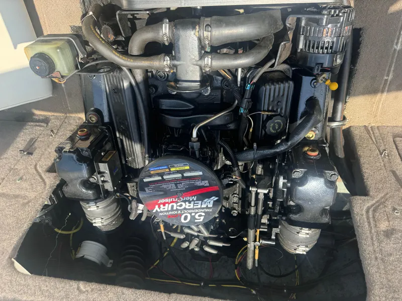 Slide: The Image of Engine of a 2003 Bayliner 212 boat, featuring a Mercury 5.0L motor. - 11
