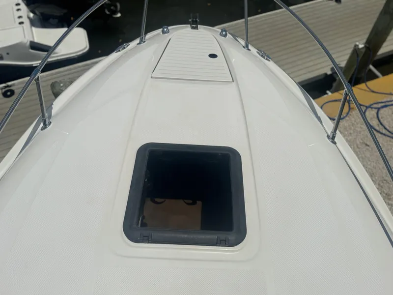 Slide: The Image of Bow of a 2003 Bayliner 212 boat with open hatch, docked at marina. - 3