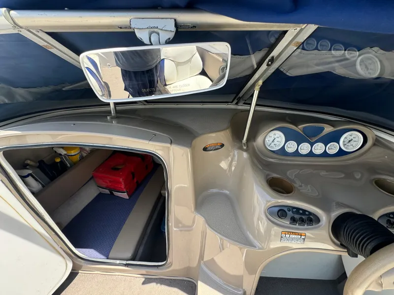 Slide: The Image of Interior view of a 2003 Bayliner 212 boat showing dashboard and cabin area. - 6