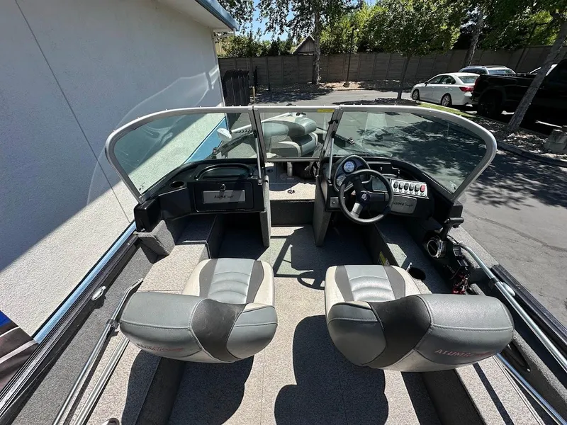 Slide: The Image of 2020 Alumacraft Classic 165 boat interior with dual seats and steering console. - 12