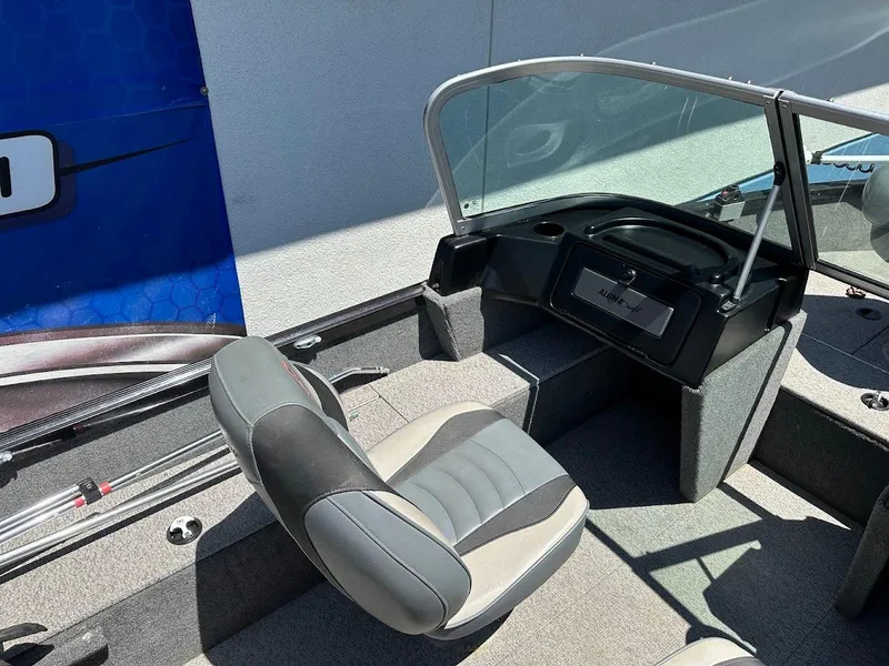 Slide: The Image of 2020 Alumacraft Classic 165 boat interior with seating and dashboard. - 16