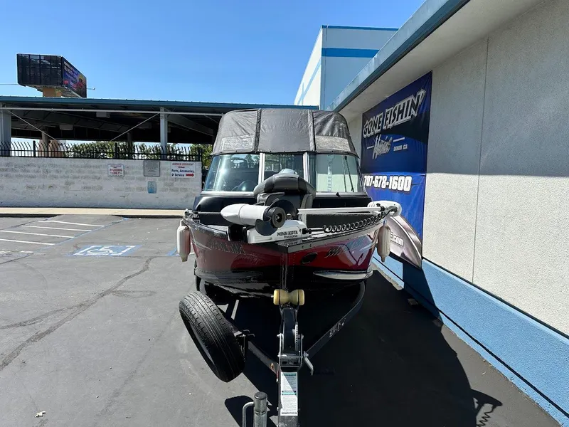 Slide: The Image of 2020 Alumacraft Classic 165 boat on trailer in parking lot. - 2