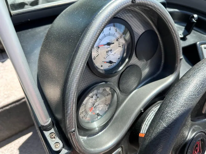 Slide: The Image of Dashboard of 2020 Alumacraft Classic 165 boat showing RPM and volt gauges. - 20