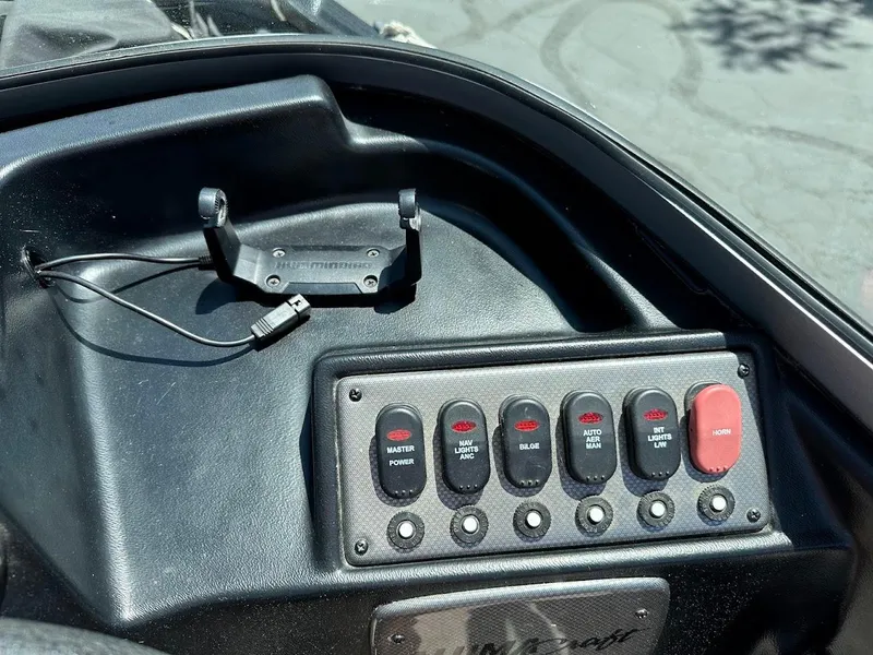 Slide: The Image of Control panel of 2020 Alumacraft Classic 165 boat with switches and device holder. - 21