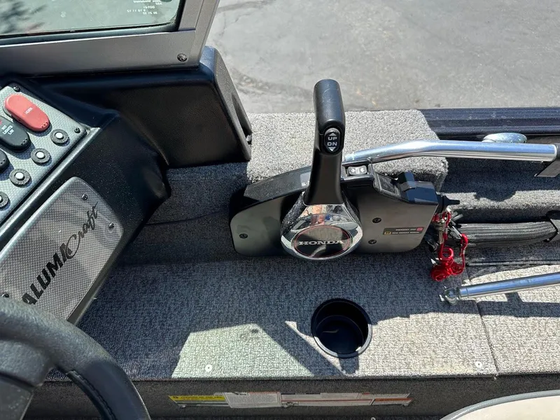 Slide: The Image of 2020 Alumacraft Classic 165 boat console with controls and steering wheel. - 22
