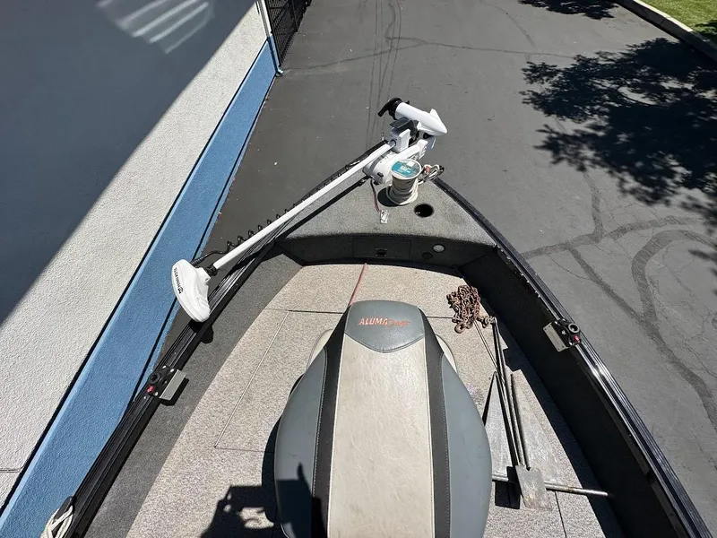 Slide: The Image of 2020 Alumacraft Classic 165 boat deck with trolling motor and fishing gear. - 24